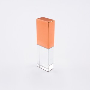 May include: A clear crystal USB drive with a copper top.