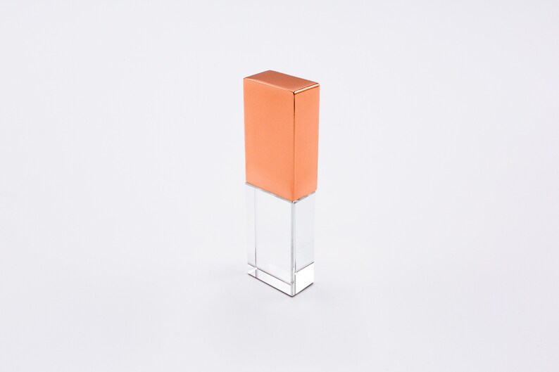 May include: A clear crystal USB drive with a copper top.