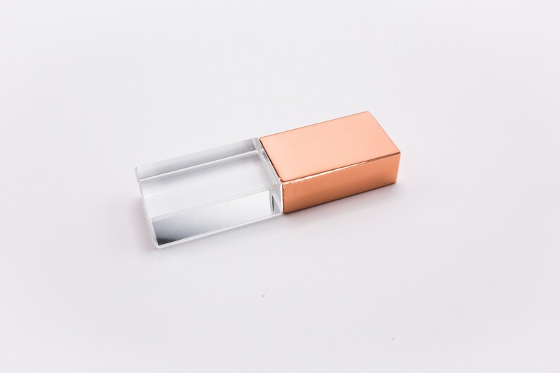 May include: A clear crystal USB drive with a copper metal cap.