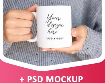 May include: White ceramic mug with a black handle. The mug has the text "Your design here" and a small heart with floral accents.