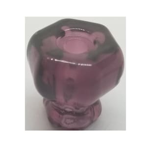 May include: A purple glass knob with a hexagonal shape. The knob has a smooth, shiny finish.