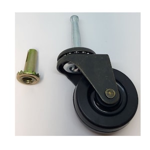 May include: Black caster wheel with a metal stem and a brass colored threaded insert. The wheel has a black rubber tire and a metal bearing.