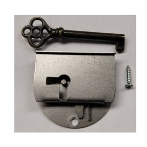 May include: A silver-toned metal lock with a keyhole and a decorative key. The lock has a round base and a rectangular top. A small silver screw is included.