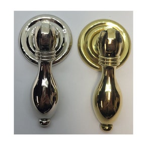 May include: Two cabinet knobs, one in polished nickel and one in polished brass, with a teardrop-shaped pull and a round base.