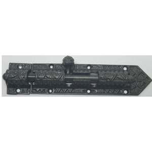 May include: Black metal door bolt with an ornate design. The bolt has a rounded knob and is secured with screws.