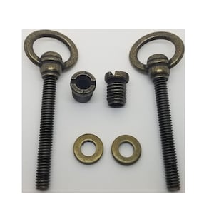 May include: Two antique gold-toned metal screw-in hooks with rings. The hooks come with two matching washers and two threaded inserts.