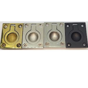 May include: Four flush-mounted cabinet pulls in different finishes: brass, nickel, chrome, and black.