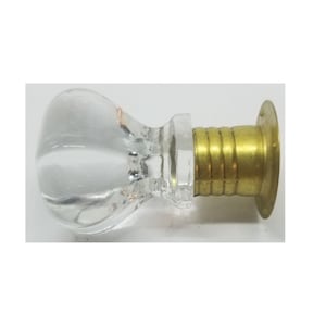 May include: A clear glass door knob with a brass base and a round, flat back plate.