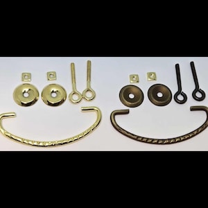May include: Two sets of hardware for a cabinet or drawer pull. Each set includes a curved handle, two round plates, two square plates, and two screws. One set is gold and the other is antique brass.