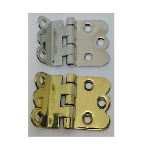 May include: Two decorative hinges, one in polished brass and one in polished nickel. Both hinges have a scalloped edge and are designed for use on doors or cabinets.