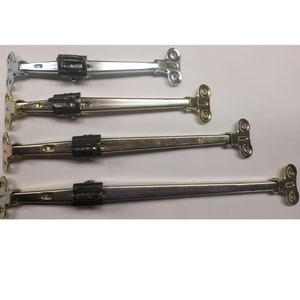 May include: Four metal cabinet door hinges in different sizes. The hinges are silver and gold in color and have a black plastic piece in the middle.