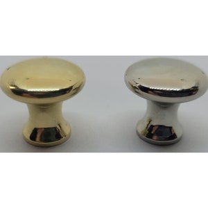 May include: Two cabinet knobs, one in polished brass and one in polished nickel.