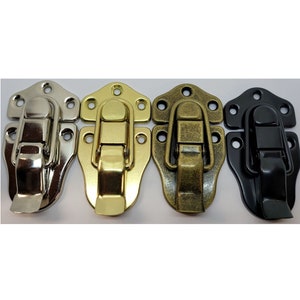 May include: Four metal clasps in different finishes: silver, gold, antique brass, and black. Each clasp has a hinged latch and four mounting holes.