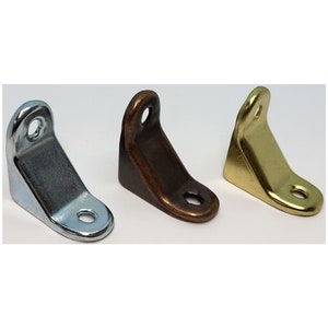 May include: Three metal corner brackets in different finishes: silver, bronze, and gold. The brackets are L-shaped and have two holes for screws.