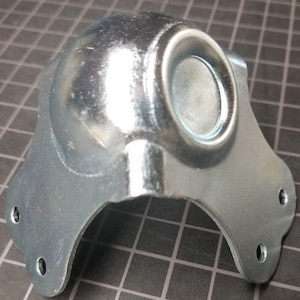 May include: Silver metal corner brace with a rounded top and three mounting holes on each side. The brace is designed to reinforce corners of furniture or other structures.