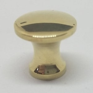 May include: A polished brass cabinet knob with a round top and a cylindrical base.