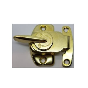 May include: A gold-toned metal cabinet latch with a lever handle and a small, round, locking mechanism. The latch has two mounting holes on each side.
