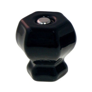 May include: Black ceramic cabinet knob with a hexagonal shape and a silver screw.