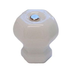 May include: White ceramic cabinet knob with a hexagonal shape and a silver metal screw.