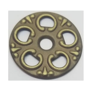 May include: A gold-colored metal decorative accent with a circular design and five openwork cutouts. The accent has a slightly raised, textured surface.