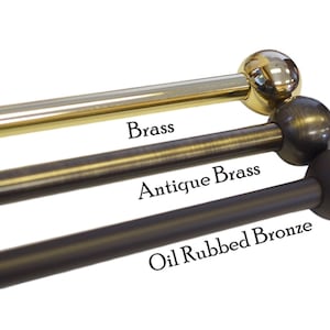 May include: Three metal curtain rods with ball finials in different finishes: brass, antique brass, and oil rubbed bronze.
