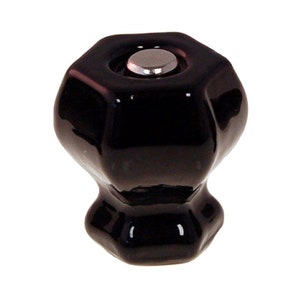 May include: Black ceramic cabinet knob with a hexagonal top and a rounded base.