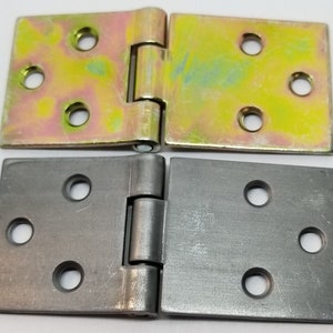 May include: Two pairs of hinges, one pair is silver and the other is gold. Both pairs have four holes on each side.