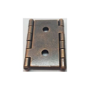 May include: Antique brass finish cabinet hinge with two holes and the word "TAIWAN" stamped on the surface.