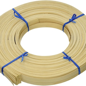 May include: A roll of natural-colored, flat, woven bamboo strips tied together with blue ribbon. The strips are approximately 1/2 inch wide and are used for crafting.