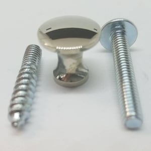 May include: A silver knob with a round top and a screw for attaching it to a surface.