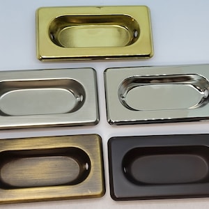 May include: Five cabinet door pulls in different finishes: polished brass, brushed nickel, antique brass, oil rubbed bronze, and polished chrome.