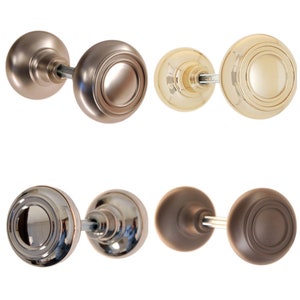 May include: Four sets of door knobs in different finishes: satin nickel, polished brass, polished chrome, and oil rubbed bronze. Each knob has a round shape with a raised ring around the center.