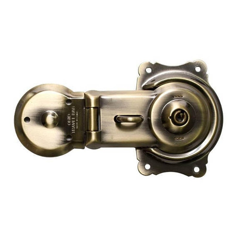 May include: Antique brass lock with a keyhole and a lever handle. The lock has a round, decorative design and the text "Ohio Heavy Duty" is engraved on the side.