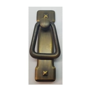 May include: Antique brass cabinet pull with a square base and a ring handle. The pull has a distressed finish and decorative accents.