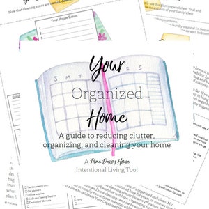 May include: A watercolor illustration of an open notebook with the words "Your Organized Home" on the cover. The notebook is a guide to reducing clutter, organizing, and cleaning your home. The text "A Pine Daisy House Intentional Living Tool" is also included on the cover.