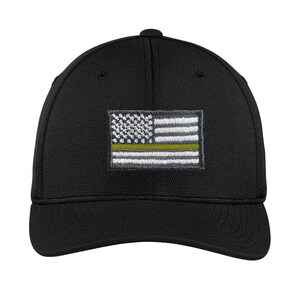 May include: Black baseball cap with an embroidered American flag with a yellow stripe. The flag is on the front of the cap.