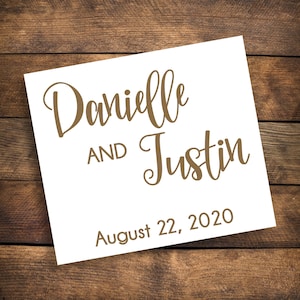 May include: White card with brown text announcing the wedding of Danielle and Justin on August 22, 2020.