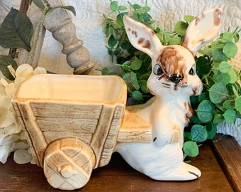 Holding a Blue Pot of Yellow Flowers Easter Vignette Vintage White Porcelain or Ceramic Easter Bunny or Rabbit Tabletop Decor Holding a Blue Pot of Yellow Flowers Easter Vignette Vintage White Porcelain or Ceramic Easter Bunny or Rabbit Tabletop Decor