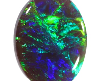 May include: A dark green and blue oval black opal gemstone with a high polish.