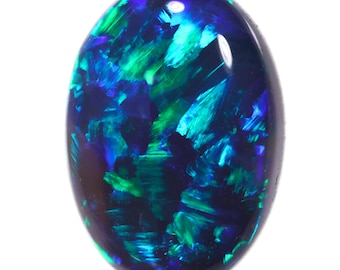 May include: A dark blue oval opal gemstone with green and blue flashes of colour.