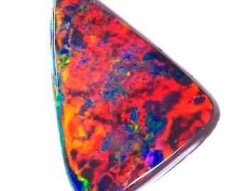 May include: A triangular, red, black, and green opal gemstone with iridescent flashes of color.