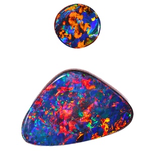 May include: Two opals with vibrant colors. The top opal is round, displaying orange, blue, and yellow hues. The bottom opal is a triangular shape, showcasing a mix of red, blue, and green colors. Both opals have a polished, glossy finish.