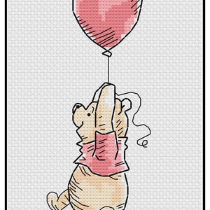 May include: Cross-stitch design featuring a cartoon bear holding onto a pink balloon. The bear is wearing a pink shirt and is suspended in the air by the balloon. The background is a white, textured fabric.