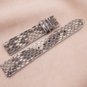 May include: Two gray and white snake skin watch straps with stitching.