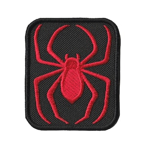 May include: Red embroidered spider patch on a black background. The spider has eight legs and a round body.
