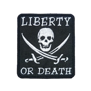 May include: Black embroidered patch with a white skull and crossbones design. The text "LIBERTY OR DEATH" is embroidered in white.