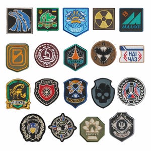 May include: A collection of nineteen embroidered fabric patches in various shapes and sizes, featuring diverse graphic designs including animals, scientific symbols, skulls, geometric patterns, and Cyrillic text in a wide array of colors.