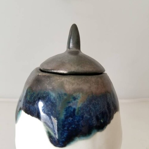 Pair of ceramic vessels shops metallic gunmetal with blues, matte white. Cute fat pinch pots with beret -ish lid and funny feet
