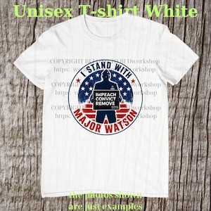 May include: A white short-sleeved t-shirt featuring a circular graphic with a blue silhouette of a person holding a sign that reads IMPEACH CONVICT REMOVE. The graphic includes red and white stripes, blue stars, and the text I STAND WITH MAJOR WATSON.