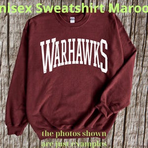 May include: Maroon unisex sweatshirt with the word "WARHAWKS" in white block letters across the chest. The sweatshirt is a crew neck style. The text "the photos shown are just examples" is at the bottom.